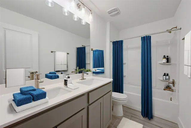 a bedroom with a large bed and a potted plant