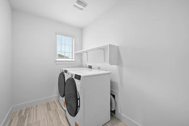 a bathroom with a double vanity sink toilet and shower