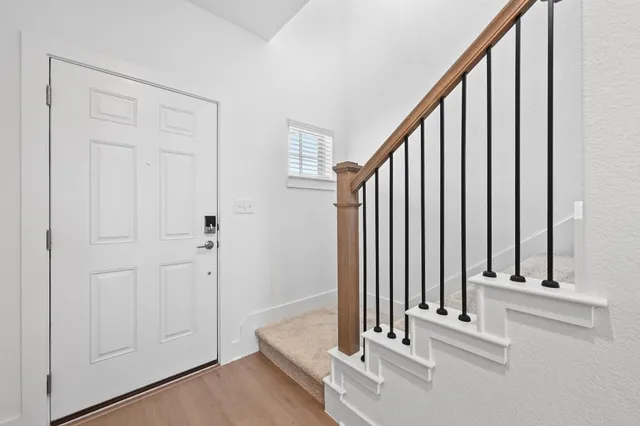 a view of a staircase with wooden floor and staircase