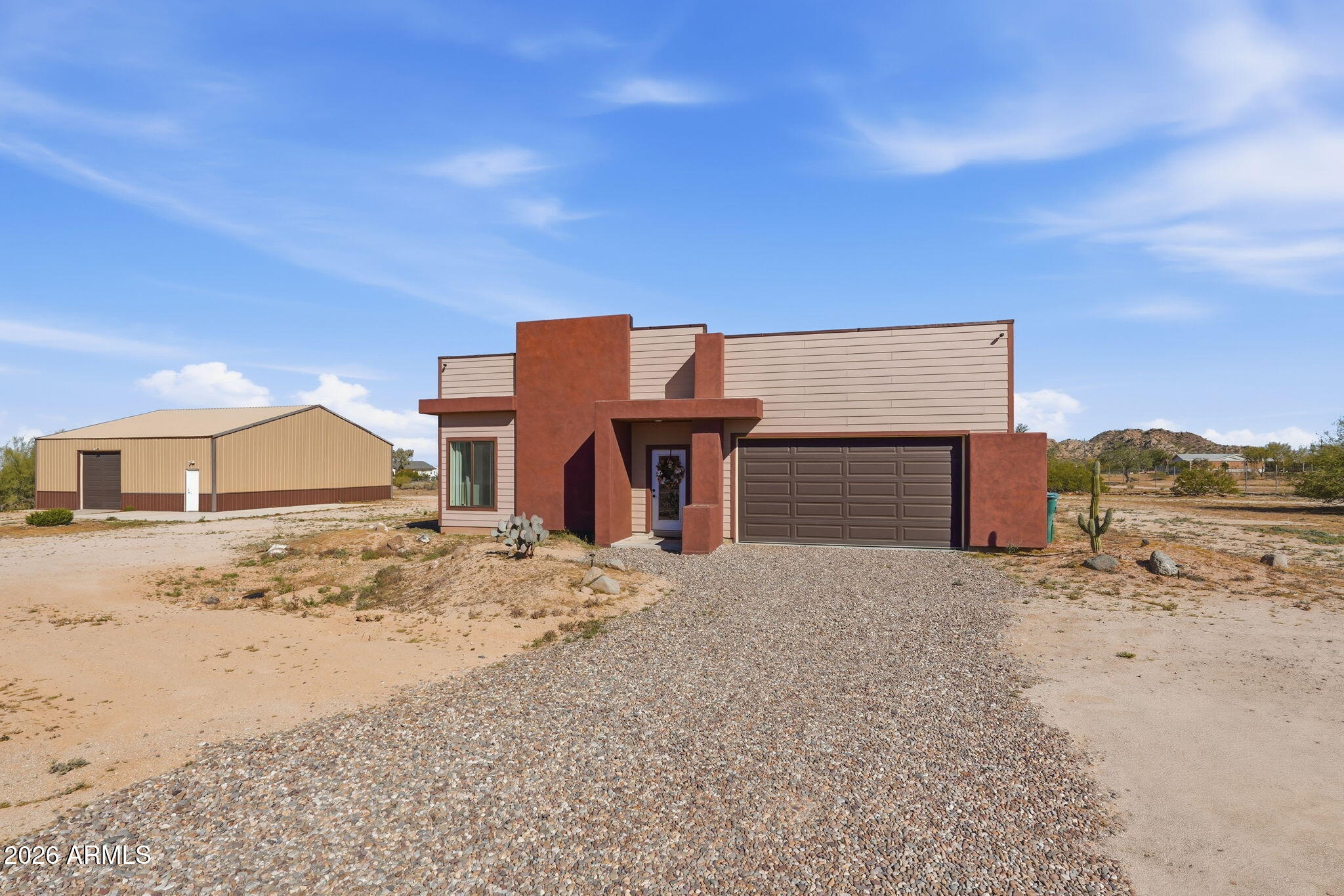 a view of a dirt road with a building in the background