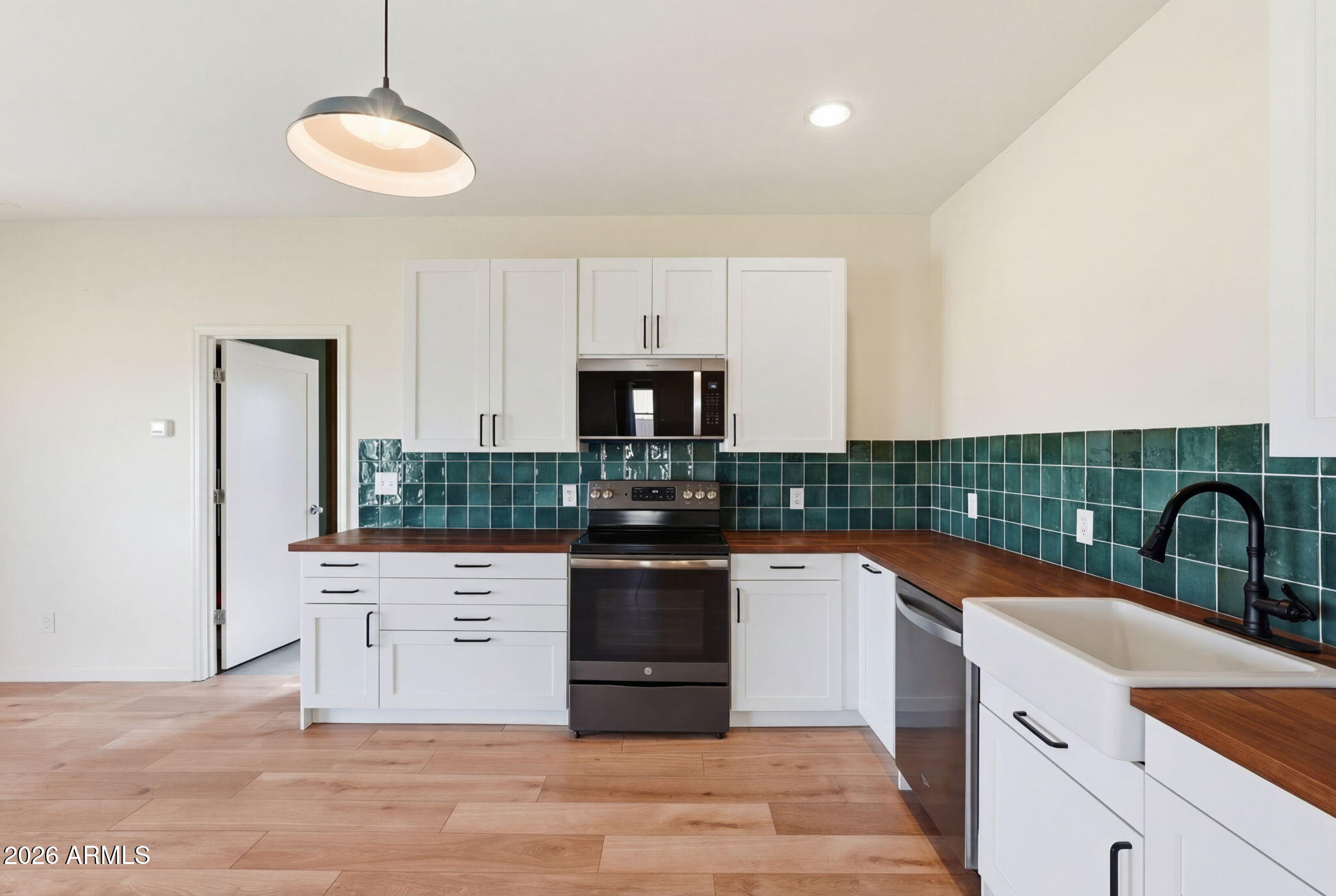 1289 South Oak Road Maricopa, AZ 85139 - Photo 11 of 39 a kitchen with stainless steel appliances granite countertop a stove and a sink