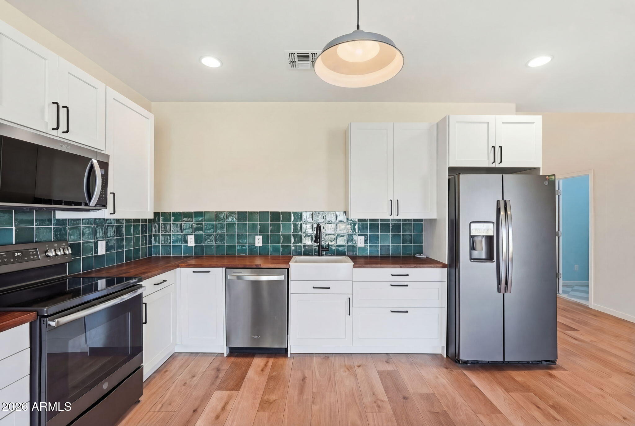 1289 South Oak Road Maricopa, AZ 85139 - Photo 13 of 39 a kitchen with a refrigerator and a stove top oven