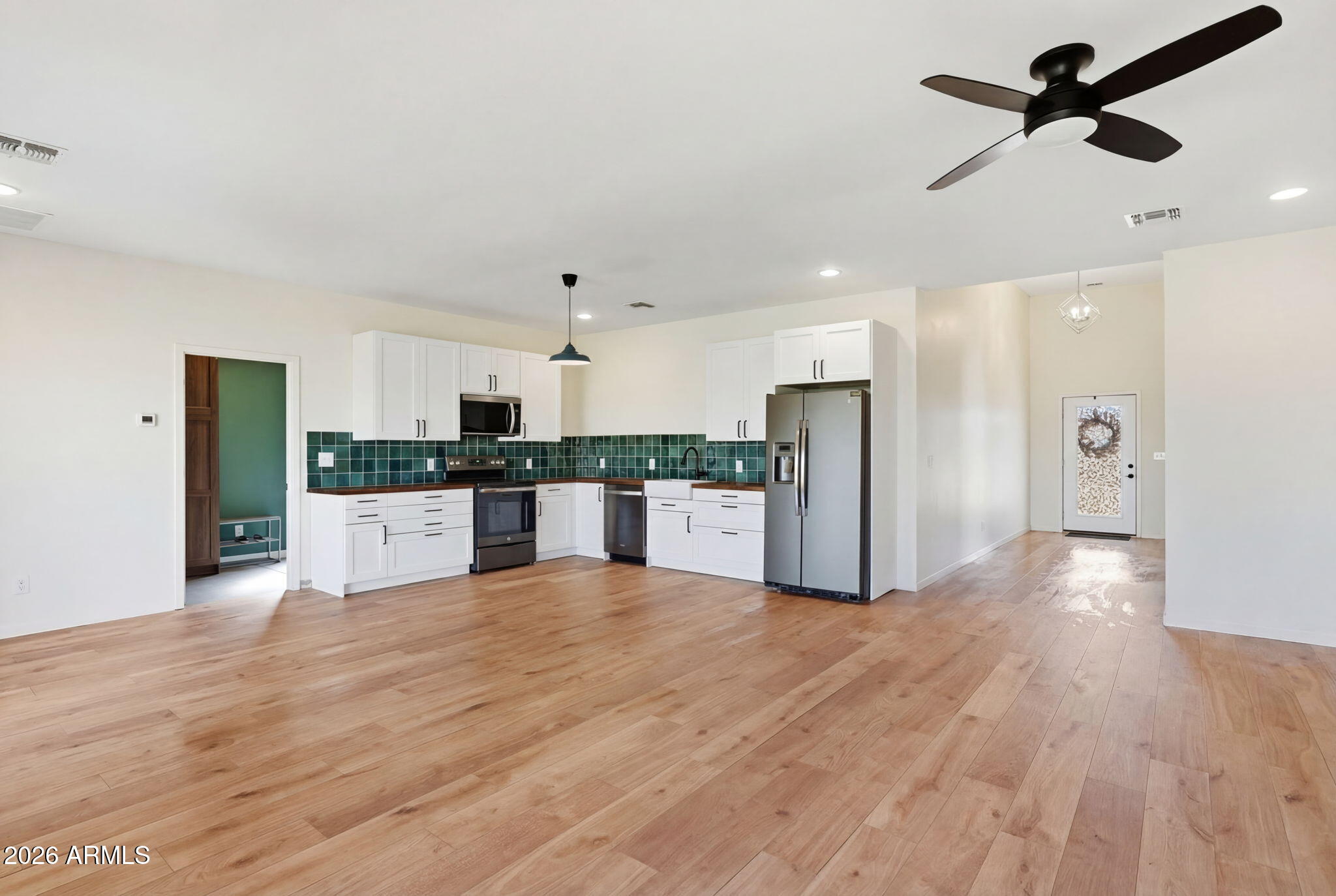 1289 South Oak Road Maricopa, AZ 85139 - Photo 15 of 39 a view of a kitchen with a sink and refrigerator