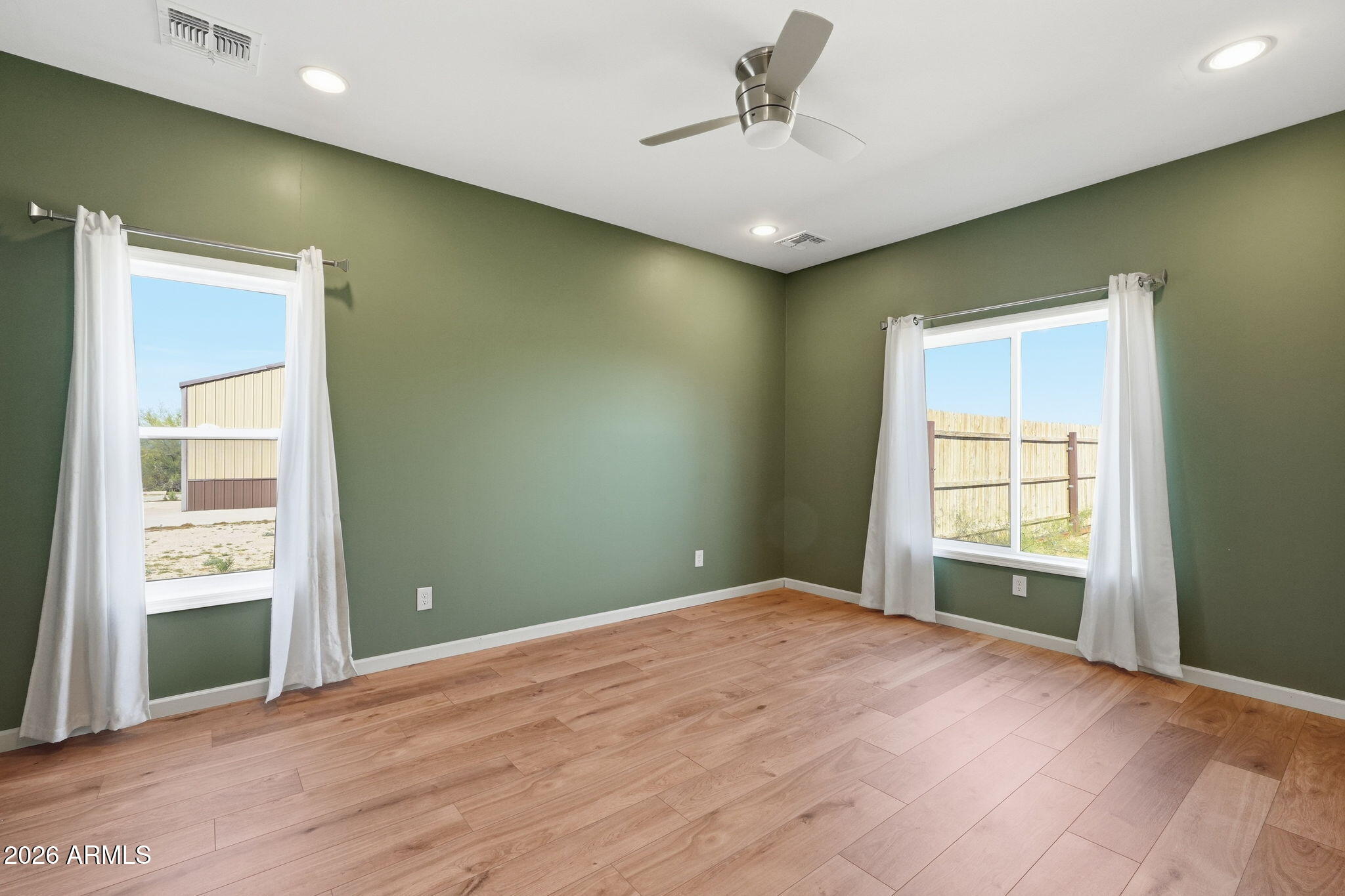 1289 South Oak Road Maricopa, AZ 85139 - Photo 20 of 39 a view of empty room with a window and wooden floor