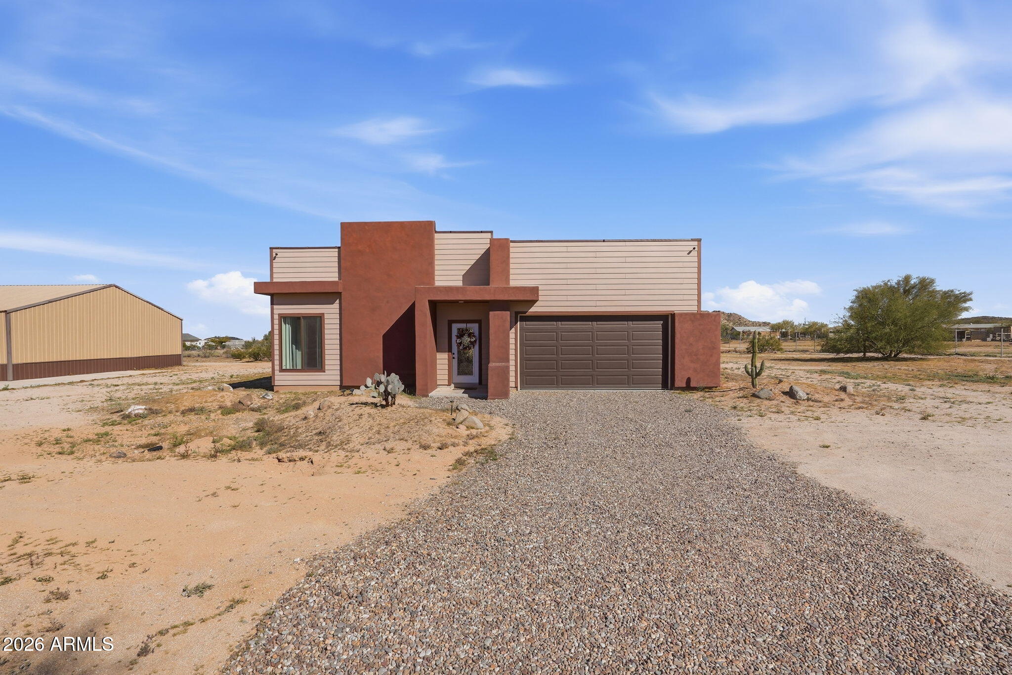 1289 South Oak Road Maricopa, AZ 85139 - Photo 2 of 39 a view of a dirt road with a building in the background