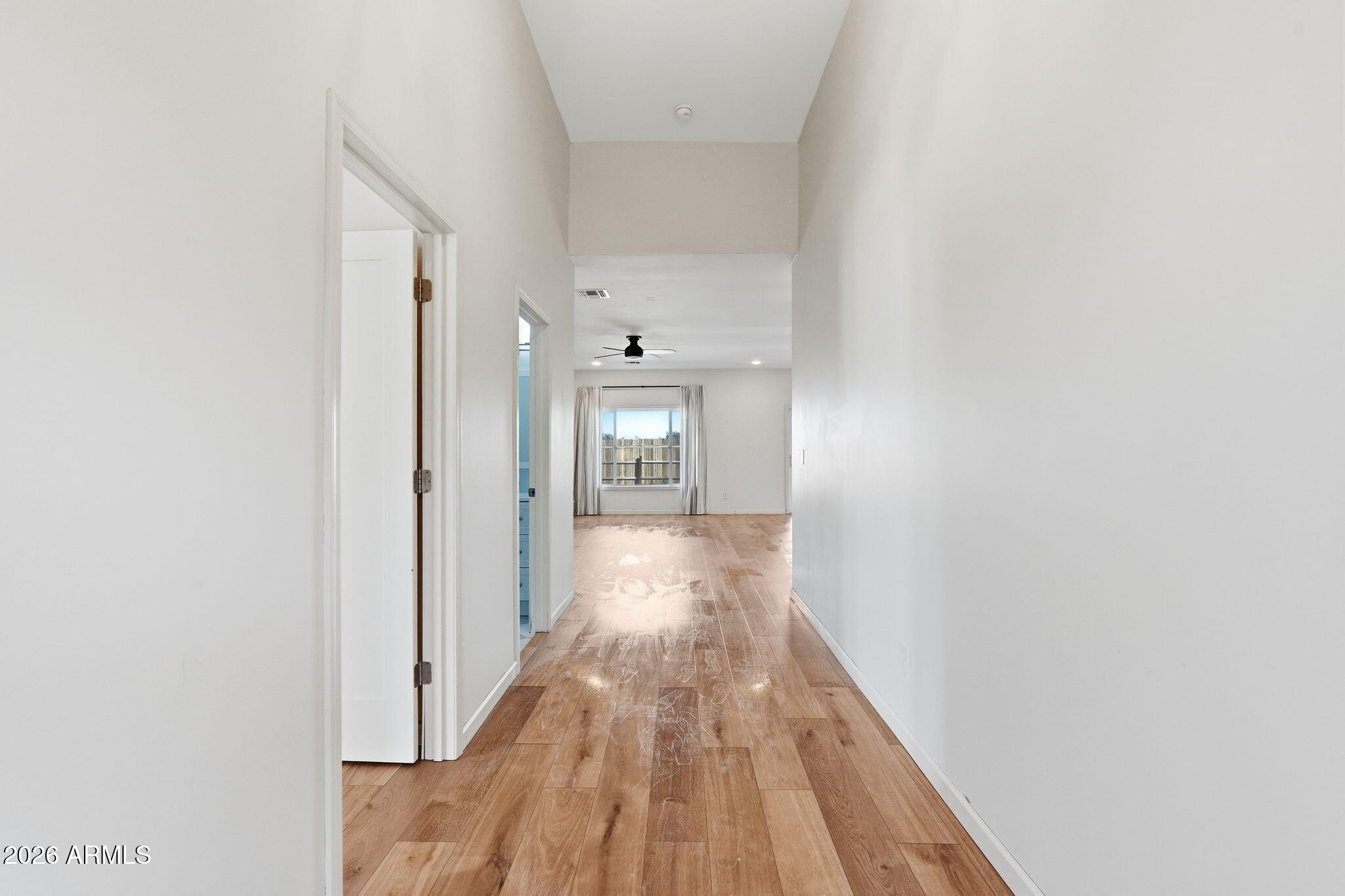 1289 South Oak Road Maricopa, AZ 85139 - Photo 6 of 39 a view of a hallway with wooden floor