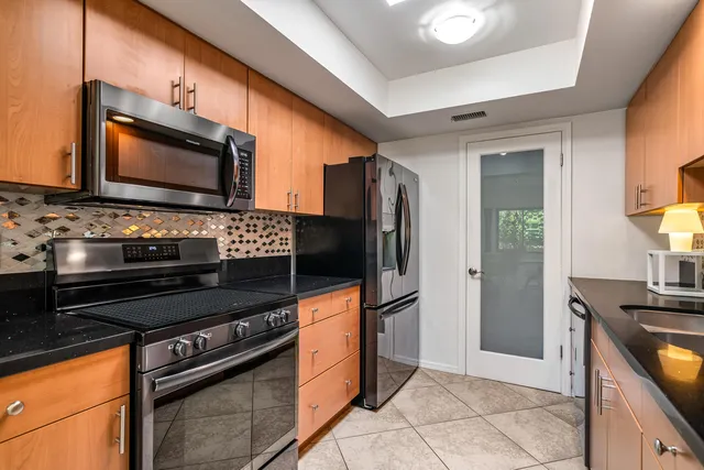 a kitchen with stainless steel appliances and cabinets