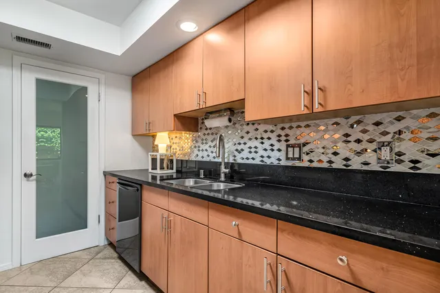 a kitchen with sink and cabinets