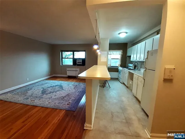 a view of an empty room and wooden floor