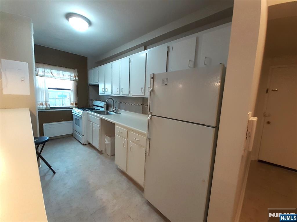 3071 Edwin Avenue, Unit 5G Fort Lee, NJ 07024 - Photo 10 of 21 a kitchen with sink cabinets and refrigerator