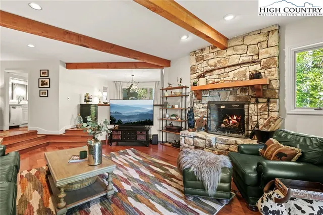 a living room with furniture a fireplace and a table