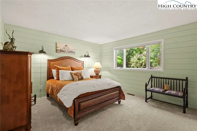 a bedroom with a bed and dresser