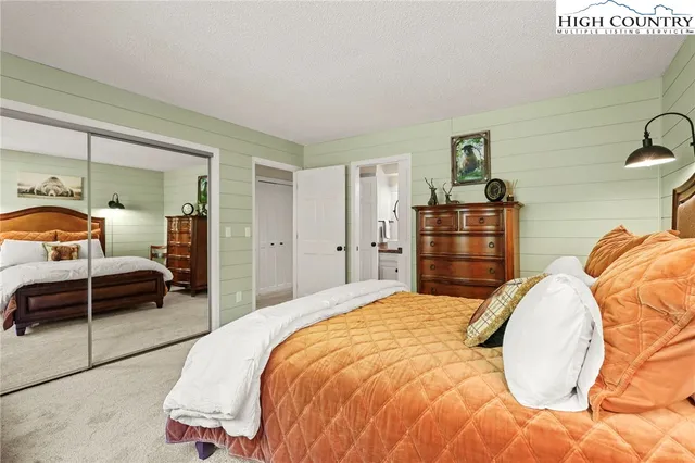 a bathroom with a granite countertop sink a toilet and a mirror