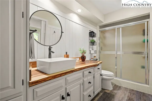 a bedroom with two beds and a large mirror