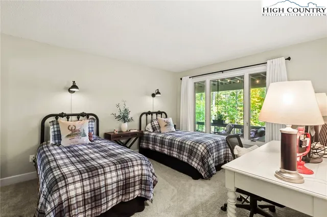 a bedroom with furniture and a flat screen tv