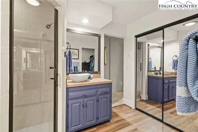 a bathroom with a granite countertop double vanity sink and a mirror