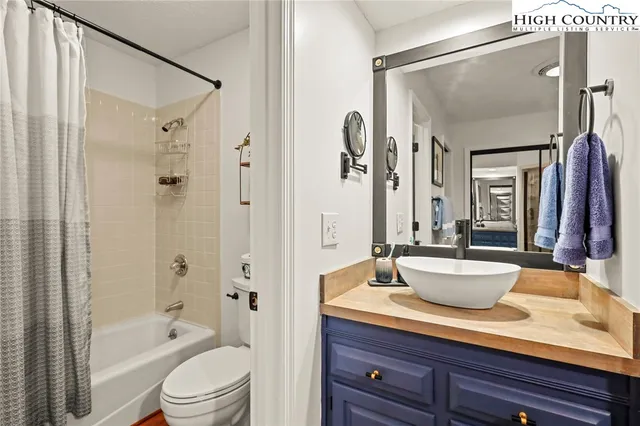 a kitchen with a refrigerator and a sink