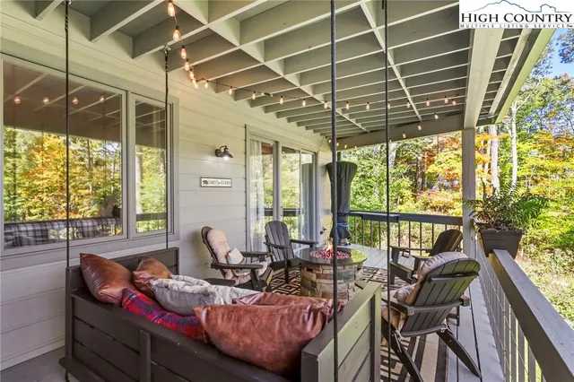 a view of a yard with plants and large trees
