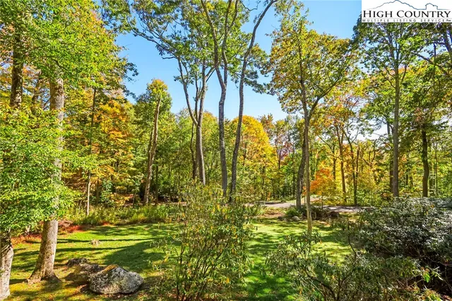 a front view of a house with a garden and garage