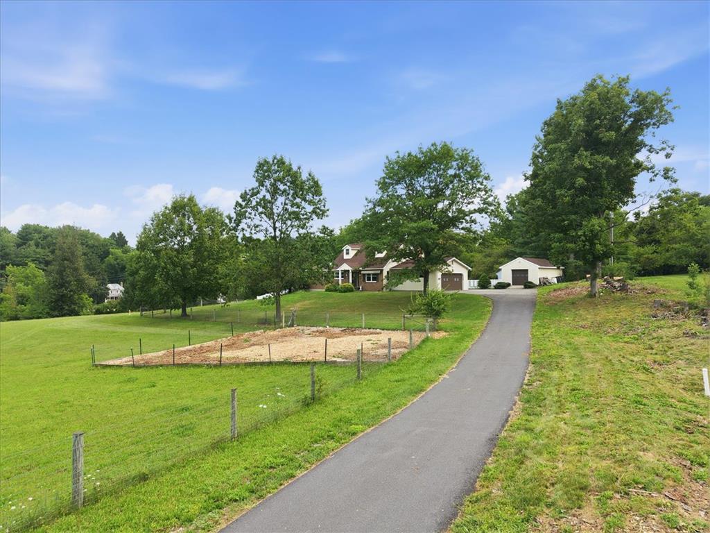 7722 Sechler Road New Tripoli, PA 18066 - Photo 3 of 58 A long paved driveway winds past green pastures toward the hillside home and outbuildings.