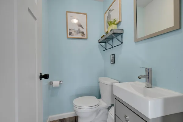 a bathroom with a toilet a sink and mirror