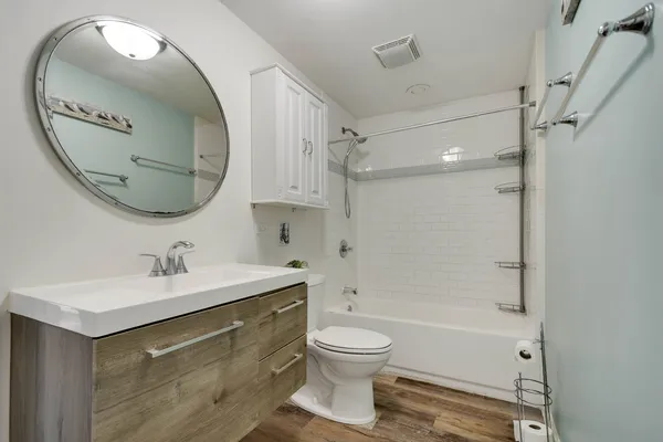 a bathroom with a sink a toilet and a mirror