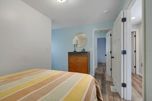 a bedroom with a bed and a dresser