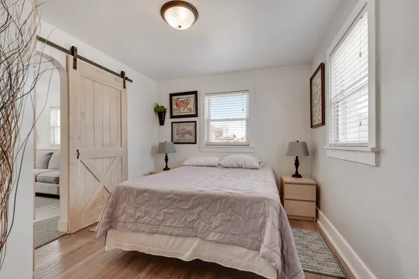 a bedroom with a bed and a window