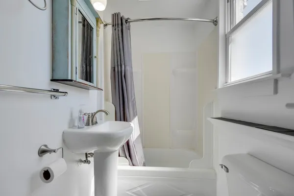 a bathroom with a sink a mirror and a bathtub