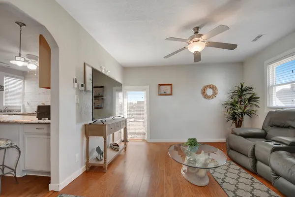 a living room with furniture and wooden floor