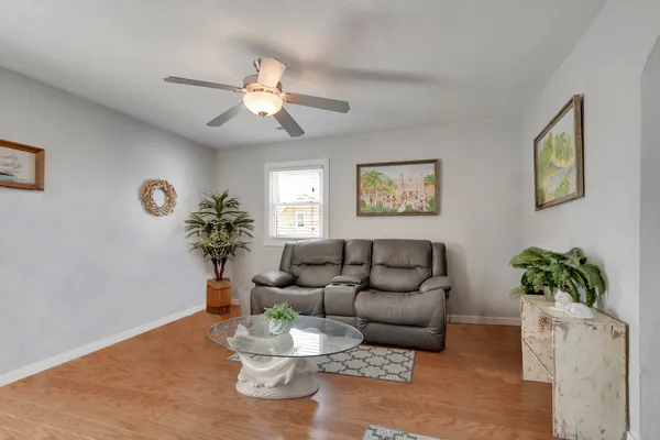 a living room with furniture and a potted plant