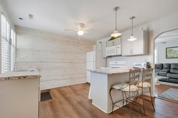 a kitchen with a cabinets and chairs