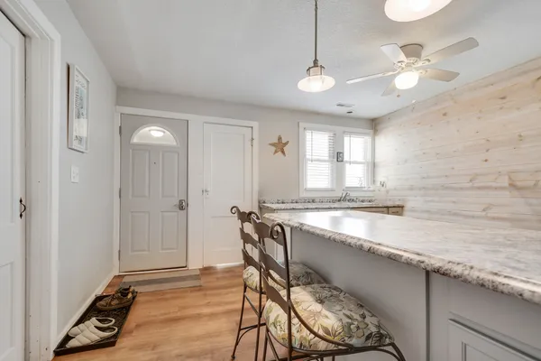a bathroom with a granite countertop sink a mirror and a bathtub