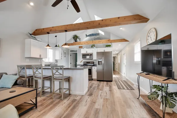 a kitchen with stainless steel appliances kitchen island granite countertop a sink and cabinets