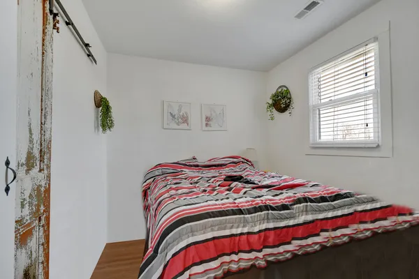 a bedroom with a bed and a window