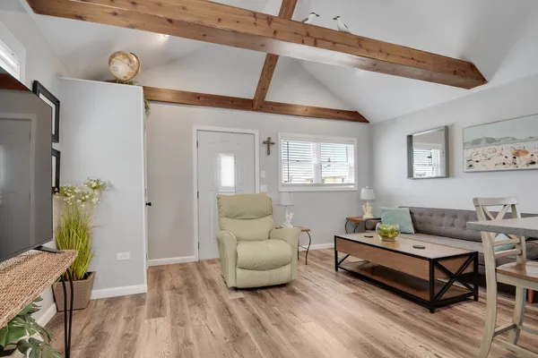 a living room with furniture and a wooden floor