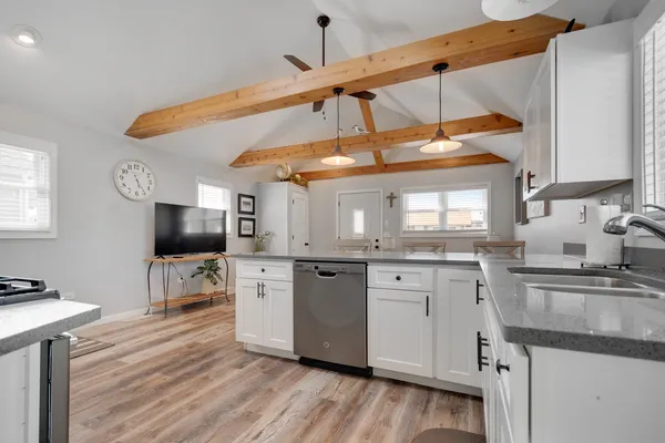 a kitchen with stainless steel appliances granite countertop a sink and cabinets