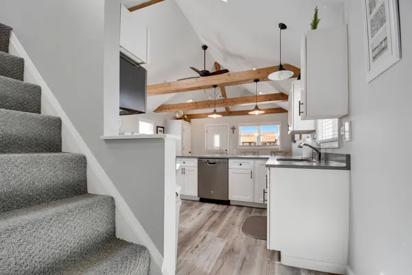 a kitchen with stainless steel appliances granite countertop a sink and a stove