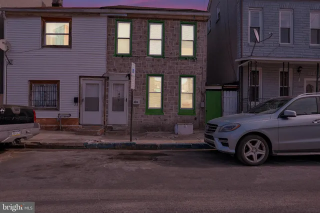 a front view of a house with parking space