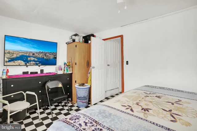 a bedroom with a bed and wooden cabinets