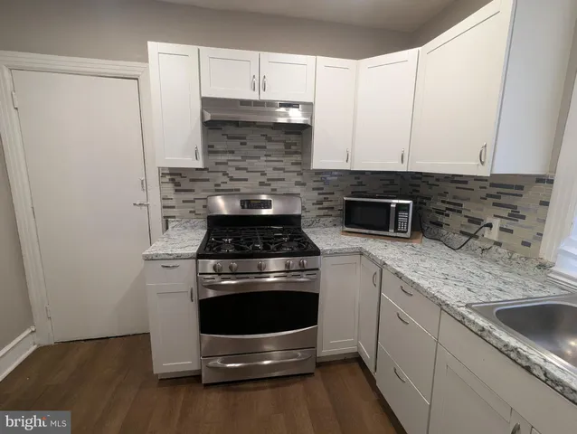 a kitchen with a stove and a sink