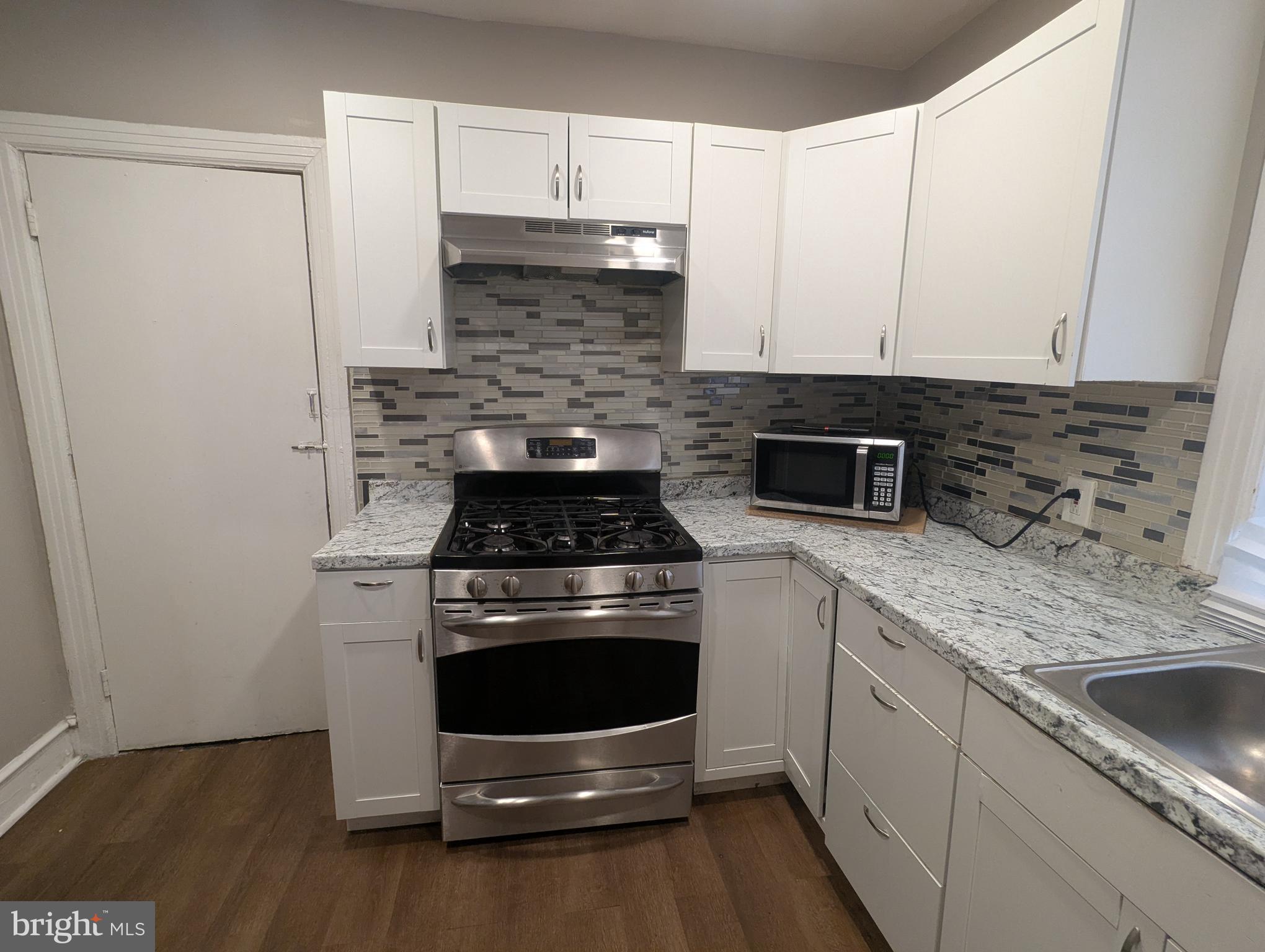 2747 North Judson Street Philadelphia, PA 19132 - Photo 4 of 18 a kitchen with a stove and a sink