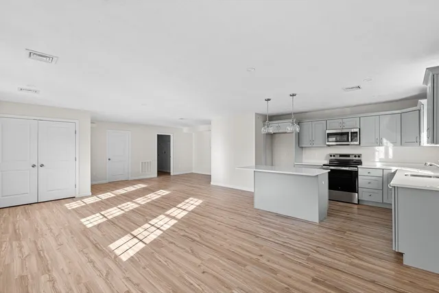 a kitchen with stainless steel appliances a white stove top oven sink and cabinets