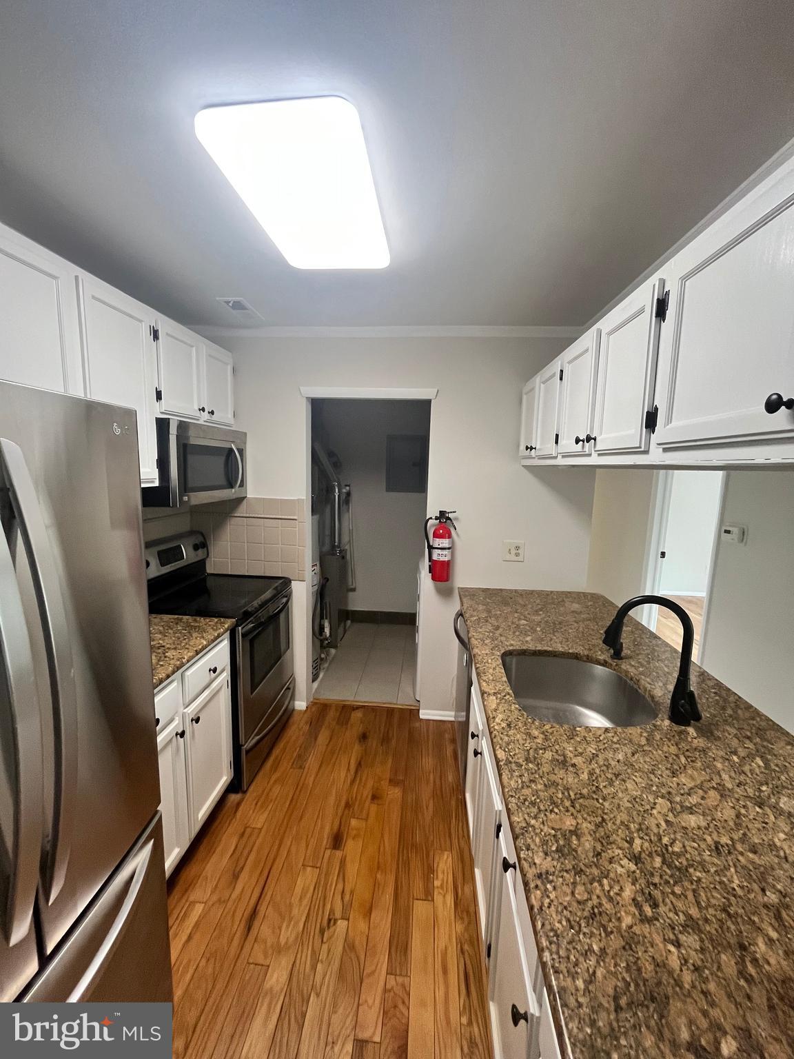 1902 The Woods Cherry Hill, NJ 08003 - Photo 4 of 17 a kitchen with granite countertop a sink stainless steel appliances and cabinets