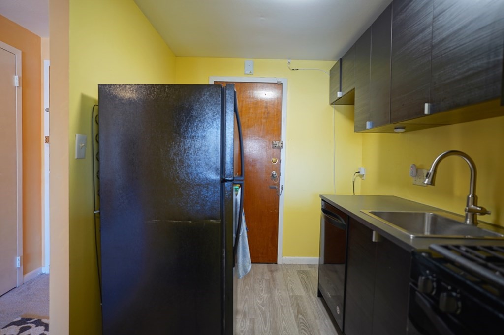 175 Clare Avenue, Unit E8 Boston, MA 02136 - Photo 11 of 25 a kitchen with a sink and a refrigerator
