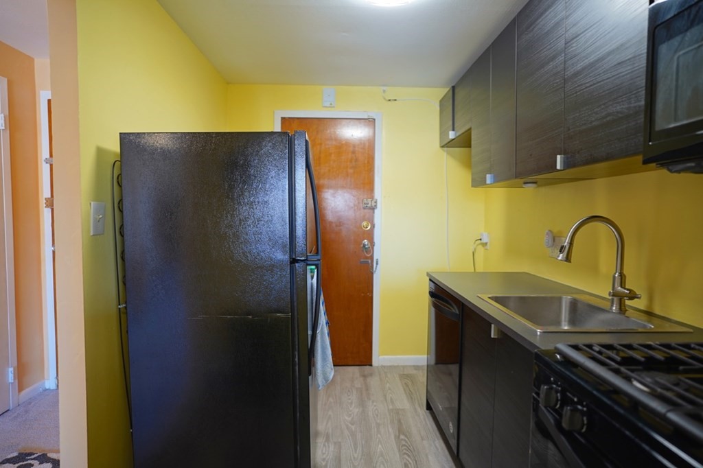 175 Clare Avenue, Unit E8 Boston, MA 02136 - Photo 12 of 25 a kitchen with a sink and a refrigerator
