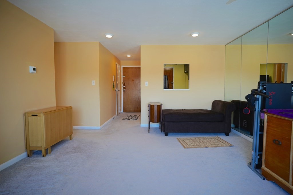 175 Clare Avenue, Unit E8 Boston, MA 02136 - Photo 14 of 25 a bedroom with furniture and a air conditioner vent