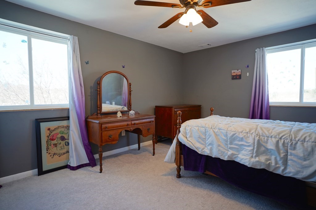 175 Clare Avenue, Unit E8 Boston, MA 02136 - Photo 17 of 25 a bed sitting in a bedroom next to a window