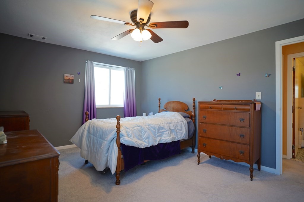 175 Clare Avenue, Unit E8 Boston, MA 02136 - Photo 18 of 25 a bedroom with a bed and a ceiling fan