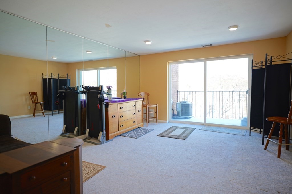 175 Clare Avenue, Unit E8 Boston, MA 02136 - Photo 2 of 25 a living room with furniture flat screen tv and large window